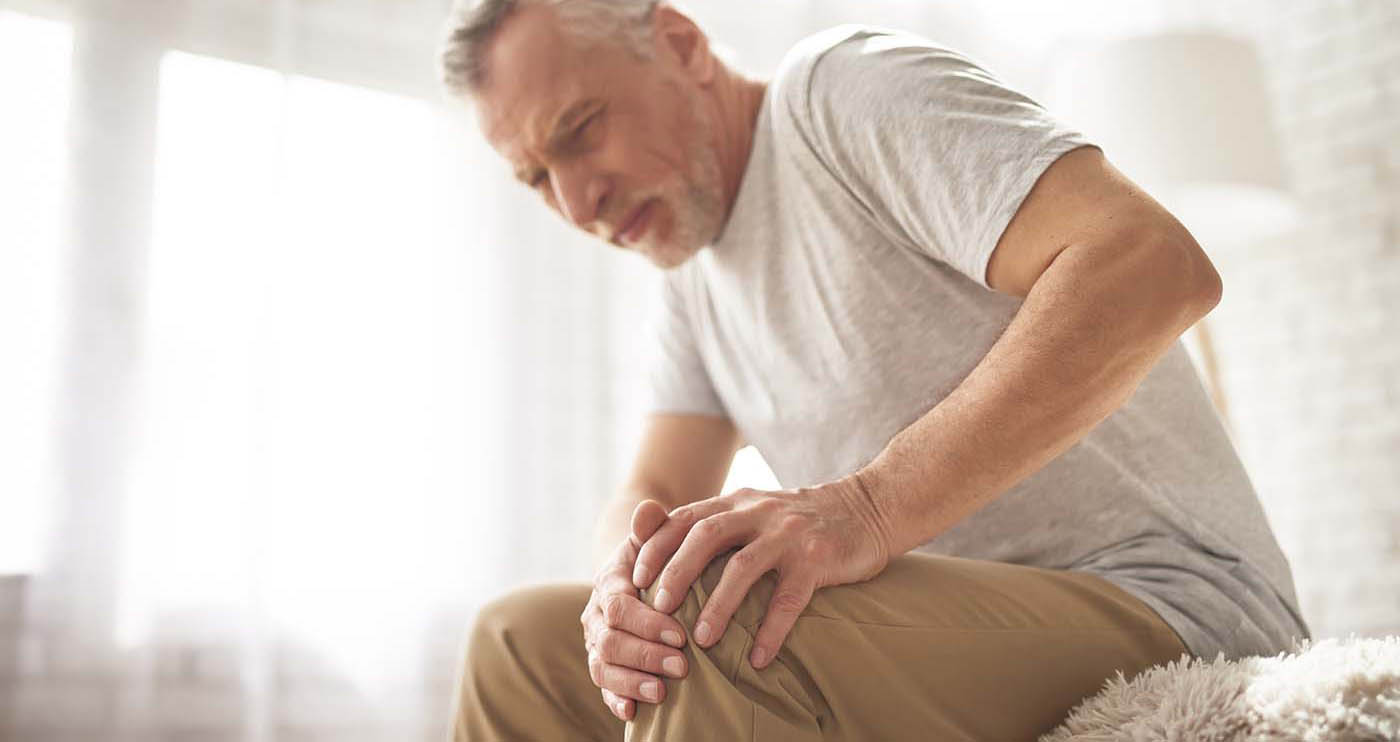 Retired Man Pensioner Suffering Knee Pain at Home.